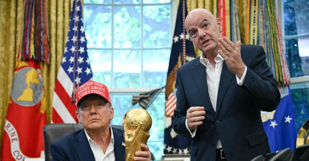 U.S. President Donald Trump (L), joined by FIFA president Gianni Infantino, holds the World Cup Trophy as he announces the Oval Office of the White House, Washington, U.S., Aug. 22, 2025. (AFP Photo)