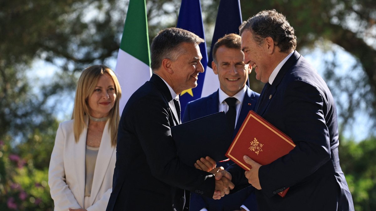 Italian Deputy Minister for Infrastructure and Transport Edoardo Rixi (2ndL) and French Minister for Transport  Philippe Tabarot (R) shake hands during an agreement signing ceremony next to French President Emmanuel Macron 2ndR) and Italian Prime Minister Giorgia Meloni 5L) as part of a Franco-Italian summit in Antibes, French Riviera, June 25, 2026. (AFP Photo)