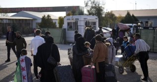 Syrians wait to cross into Syria at the Öncüpınar border gate, near the town of Kilis, southern Türkiye, Dec. 9, 2024. (AP Photo)