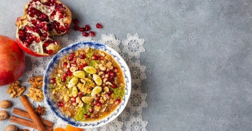 A cup of traditional Turkish dessert ashura is served with pomegranate, cinnamon, walnuts. (Shutterstock Photo)