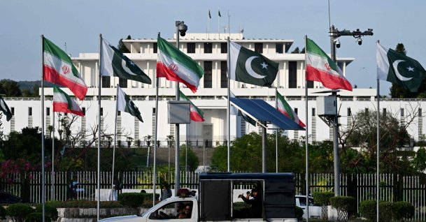 Police personnel ride past the national flags of Pakistan and Iran fluttering outside the President's House, Islamabad, Pakistan, June 22, 2026. (AFP Photo)