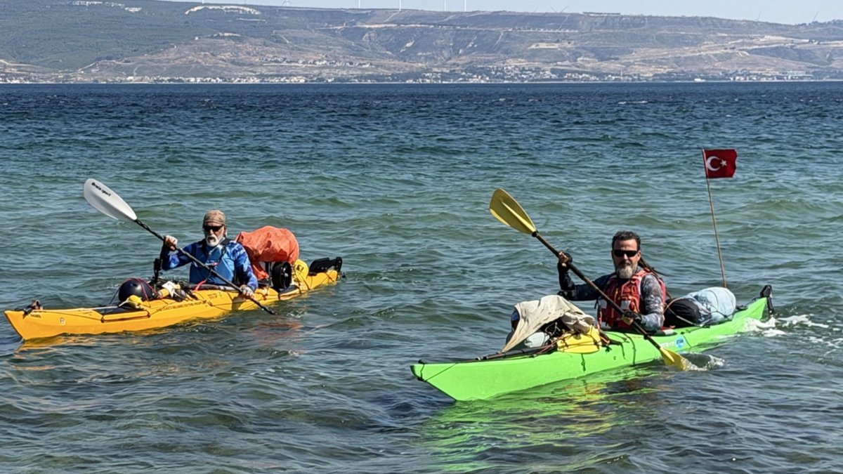 Kayakers Onur Çağlar and Halil Uzel paddle along the Çanakkale Strait during a coastal expedition to promote water sports, Çanakkale, Türkiye, June 25, 2026. (AA Photo)