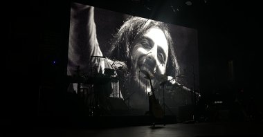 A portrait of legendary musician Kazım Koyuncu is displayed during a commemoration concert, Istanbul, Türkiye, June 20, 2026. (AA Photo)