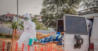 Healthcare workers carry on a stretcher a patient suffering from the Ebola virus disease from an ambulance at the Ebola Treatment Center (ETC) in Bunia, Ituri, DRC, June 23, 2026. (AFP Photo)
