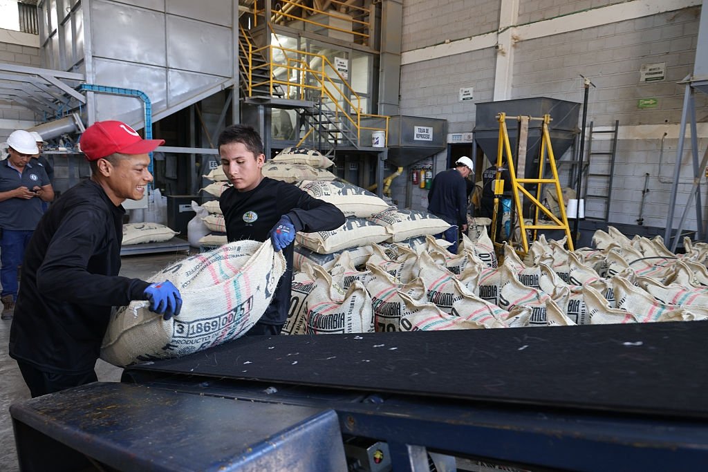Workers load bags of coffee to be shipped from a milling warehouse, Neiva, Colombia, June 26, 2025. (Getty Images Photo)