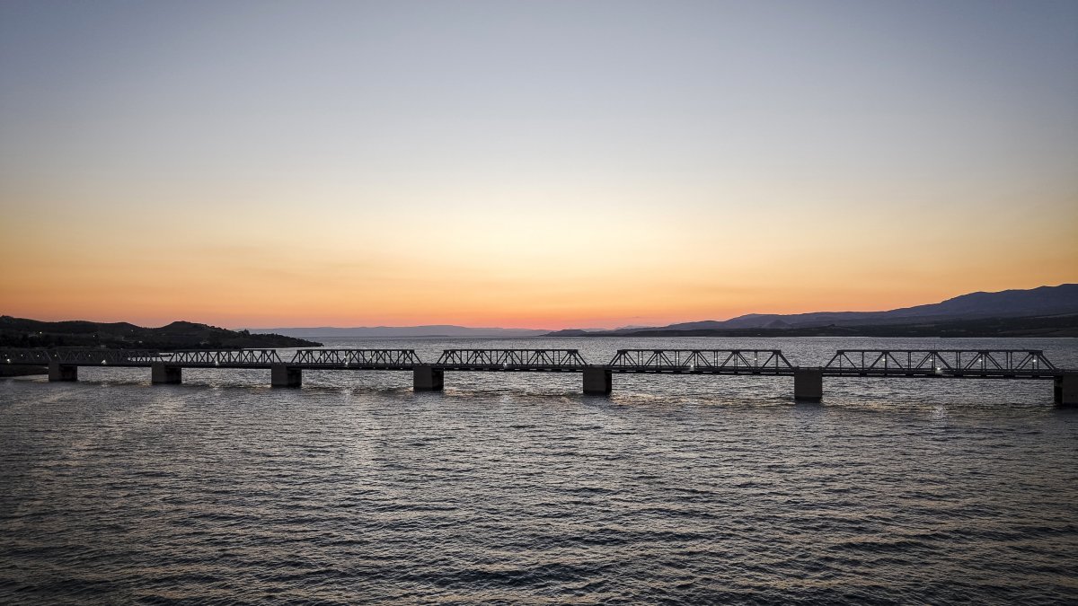 The Euphrates Railway Bridge is seen at sunset over Karakaya Dam Lake, Malatya, Türkiye, June 25, 2026. (AA Photo)