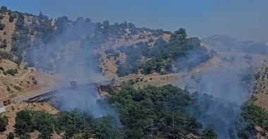 Firefighting teams work to contain a forest fire in the Onikişubat district, Kahramanmaraş, Türkiye, June 27, 2026. (AA Photo) 