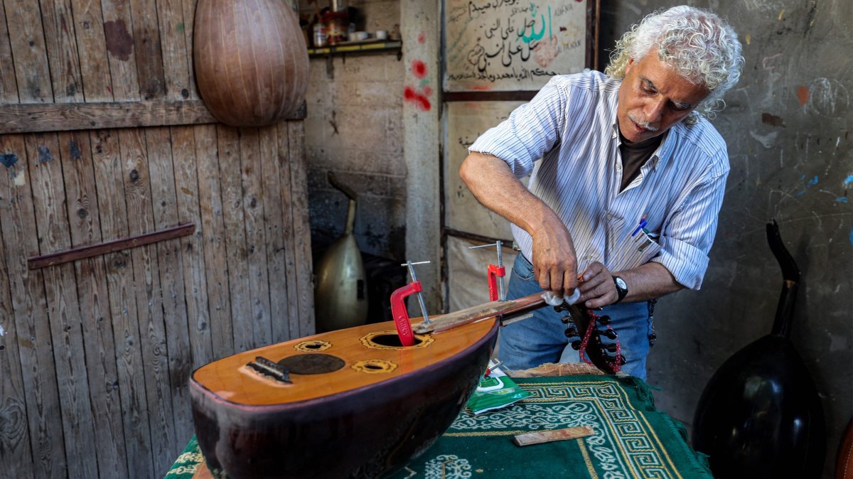 Palestinian craftsman Suhail Abu Shawish glues an oud he is repairing at his workshop, central Gaza Strip, Palestine, June 23, 2026. (AFP Photo)