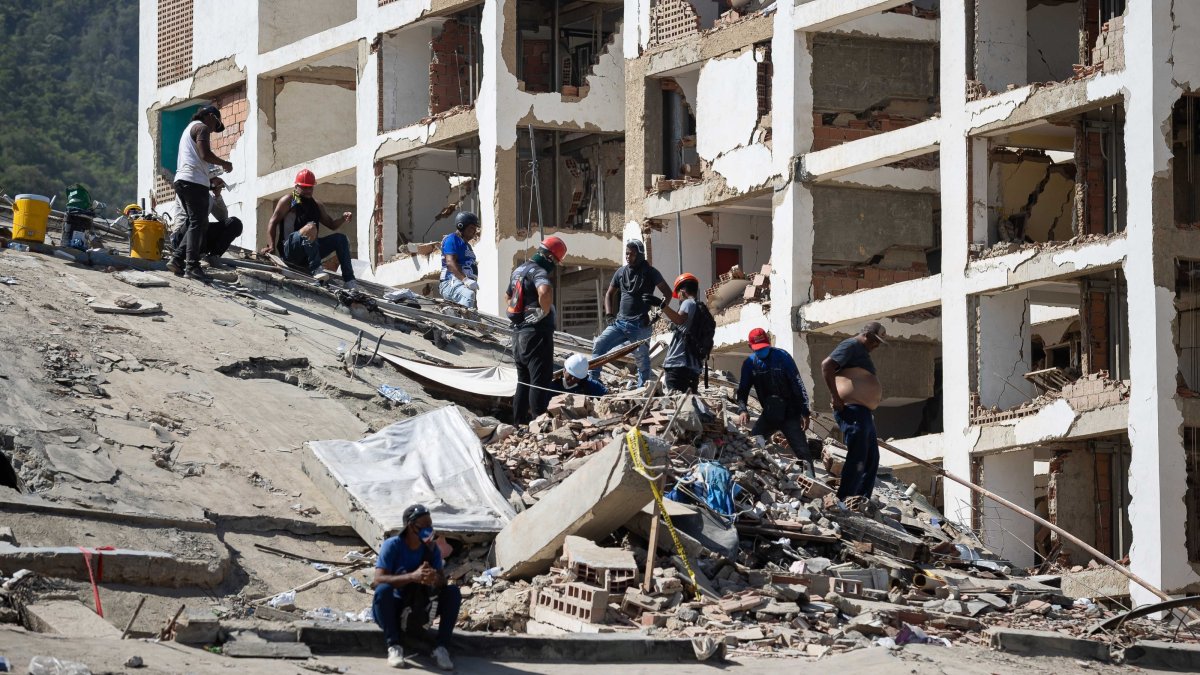 Volunteers conduct search operations in a building damaged by an earthquake in La Guaira, Venezuela, June 29, 2026. (EPA Photo)