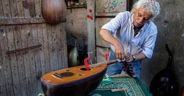 Palestinian craftsman Suhail Abu Shawish glues an oud he is repairing at his workshop, central Gaza Strip, Palestine, June 23, 2026. (AFP Photo)