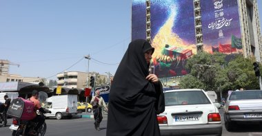 An Iranian woman walks past a billboard for the upcoming funeral of Iran's late Supreme Leader Ayatollah Ali Khamenei in Vanak Square, Tehran, Iran, June 29, 2026. (EPA Photo)