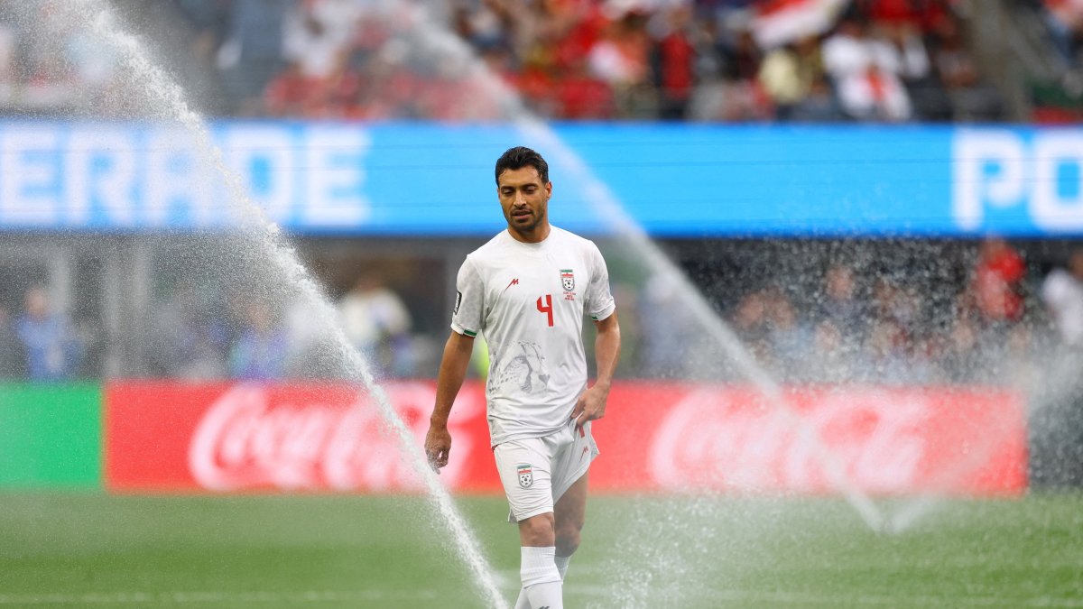 General view of sprinklers watering the pitch and Iran's Shoja Khalilzadeh during the 2026 FIFA World Cup Group G between Egypt and Iran at Seattle Stadium, Seattle, U.S., June 26, 2026. (Reuters Photo)