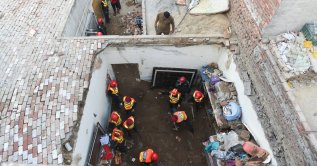 Rescue workers work at the site where children reportedly died after a tuition center roof collapsed, in Lahore, Pakistan, June 30, 2026. (Reuters Photo)