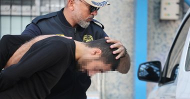 An alleged Daesh leader detained by Türkiye's National Intelligence Organization (MIT) during a counterterrorism operation near the border is escorted by police, Konya, Türkiye, June 19, 2026. (IHA Photo)