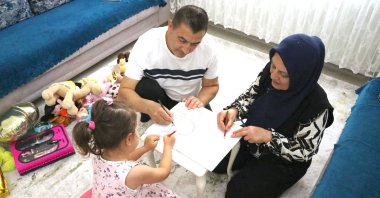 Gülcan and Hacı Cemil Bulut play with their foster daughter, Gaziantep, Türkiye, June 23, 2026. (AA Photo)