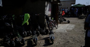 Electric scooters are parked as undocumented migrants queue for help completing paperwork to regularize their migration status in Nijar, Spain, April 22, 2026. (Reuters Photo)