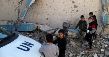 Displaced Palestinian children sit on rubble from a destroyed building near the United Nations Relief and Works Agency for Palestine Refugees in the Near East's (UNRWA) headquarters in Gaza City, Jan. 11, 2026. (AFP File Photo)