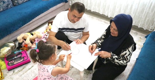 Gülcan and Hacı Cemil Bulut play with their foster daughter, Gaziantep, Türkiye, June 23, 2026. (AA Photo)