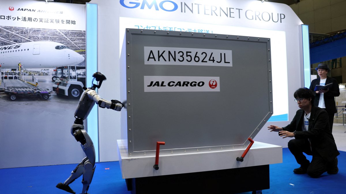Humanoid robot Unitree G1 pushes a mock cargo container during an airport ground-handling demonstration at the GMO Internet Group booth during Japan Drone Expo 2026, Chiba, Japan, June 5, 2026. (Reuters Photo)