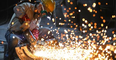 A worker polishes parts at a manufacturing company, Hangzhou, eastern China's Zhejiang province, June 23, 2026. (AFP Photo)