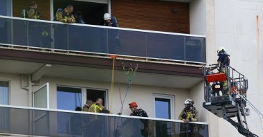 Rescuers work at the site of a fire in an housing building in Antwerp, Belgium, July 1, 2026. (Reuters Photo)
