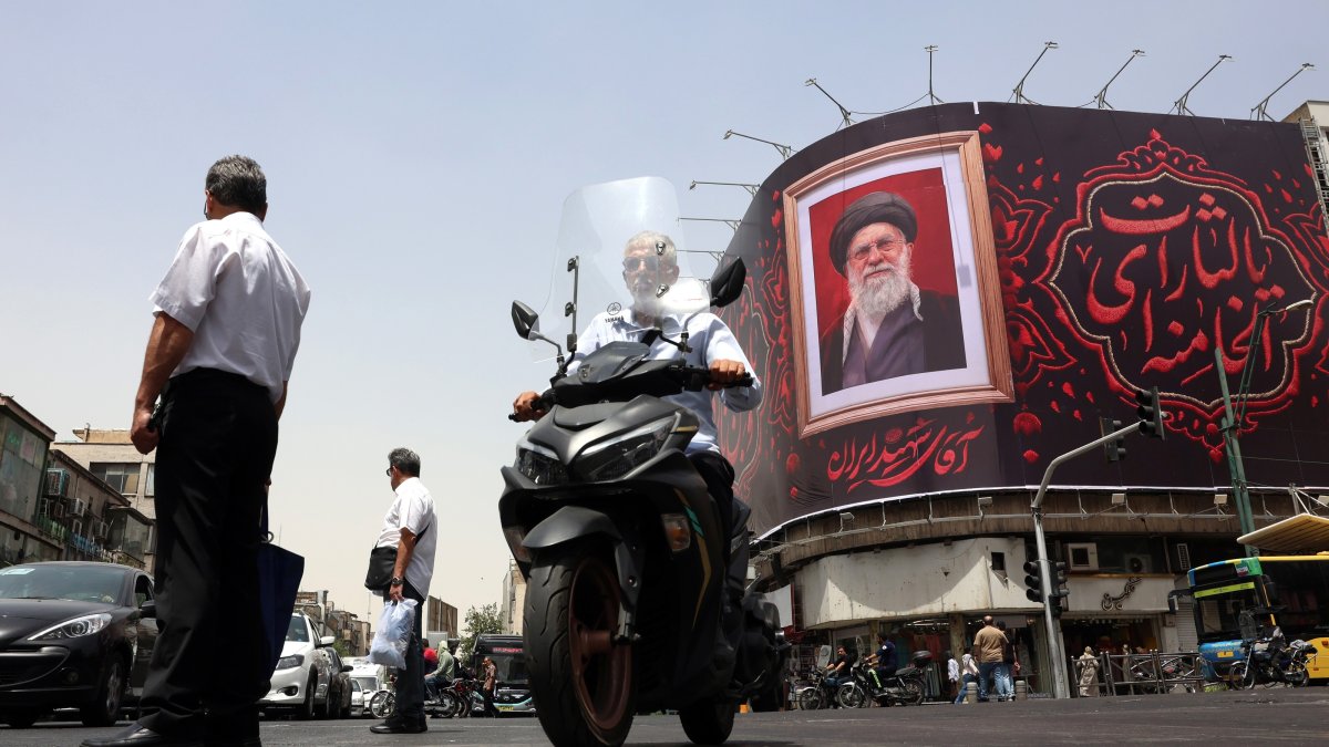 Iranian people pass a large-scale banner of late Iranian Supreme Leader Ayatollah Ali Khamenei, ahead of his funeral in Tehran, Iran, July 2, 2026. (EPA Photo)