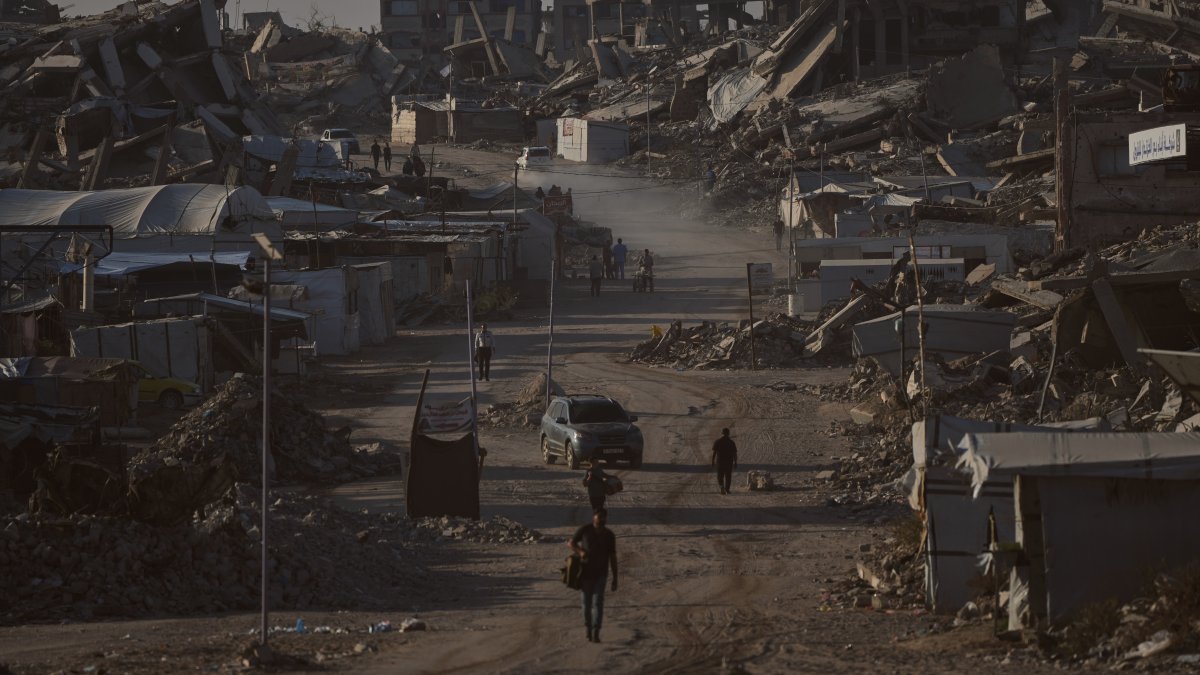Palestinians walk along a road surrounded by buildings destroyed in Israeli military strikes in Jabaliya, Gaza Strip, Thursday, July 2, 2026. (AP Photo)