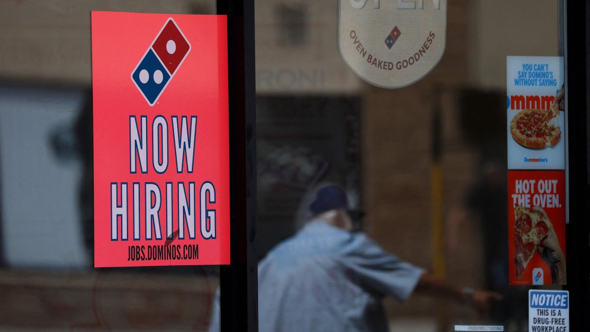 A now-hiring sign is posted in the window of a Domino's Pizza restaurant in Los Angeles, California, U.S., June 5, 2026. (AFP Photo)