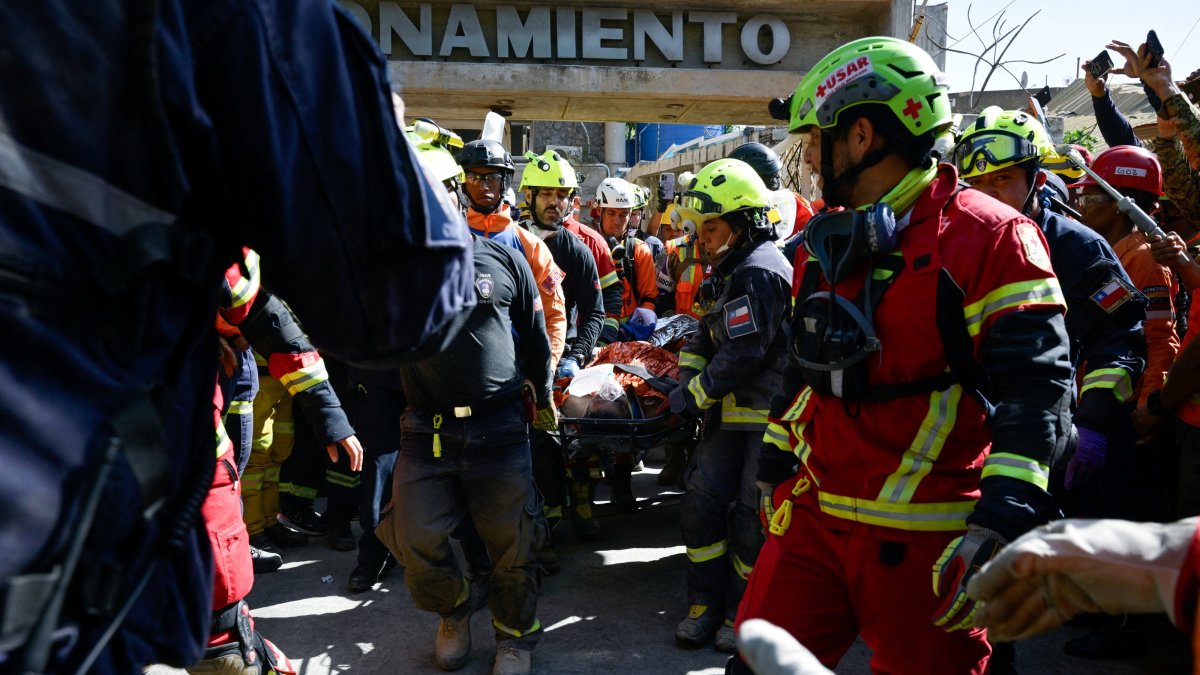 Rescue workers transport survivor Hernan Alberto Gil, who was trapped for over a week following the June 24 earthquakes, from a collapsed mall in La Guaira, Venezuela, July 2, 2026. (Reuters Photo)
