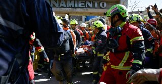 Rescue workers transport survivor Hernan Alberto Gil, who was trapped for over a week following the June 24 earthquakes, from a collapsed mall in La Guaira, Venezuela, July 2, 2026. (Reuters Photo)