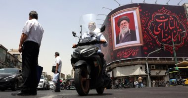 Iranian people pass a large-scale banner of late Iranian Supreme Leader Ayatollah Ali Khamenei, ahead of his funeral in Tehran, Iran, July 2, 2026. (EPA Photo)