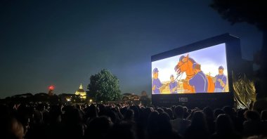 A crowd watches an animated film at "Cinema in Piazza," Rome, Italy. (Photo courtesy of Cinema in Piazza)