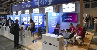 Türkiye’s Investment and Finance Office staff welcome visitors at the national pavilion during a GITEX AI event, Berlin, Germany, July 2, 2026. (AA Photo)