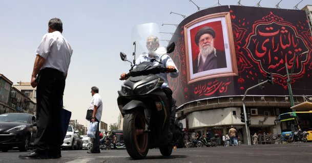 Iranian people pass a large-scale banner of late Iranian Supreme Leader Ayatollah Ali Khamenei, ahead of his funeral in Tehran, Iran, July 2, 2026. (EPA Photo)