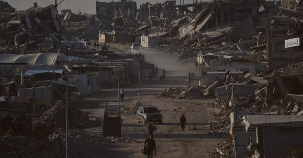 Palestinians walk along a road surrounded by buildings destroyed in Israeli military strikes in Jabaliya, Gaza Strip, Thursday, July 2, 2026. (AP Photo)