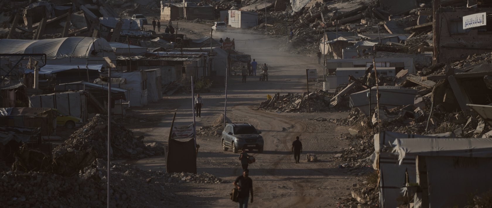 Palestinians walk along a road surrounded by buildings destroyed in Israeli military strikes in Jabaliya, Gaza Strip, Thursday, July 2, 2026. (AP Photo)