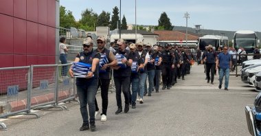 FETÖ suspects are escorted to the courthouse by security personnel carrying case files, Gaziantep, southeastern Türkiye, July 2, 2026. (IHA Photo)