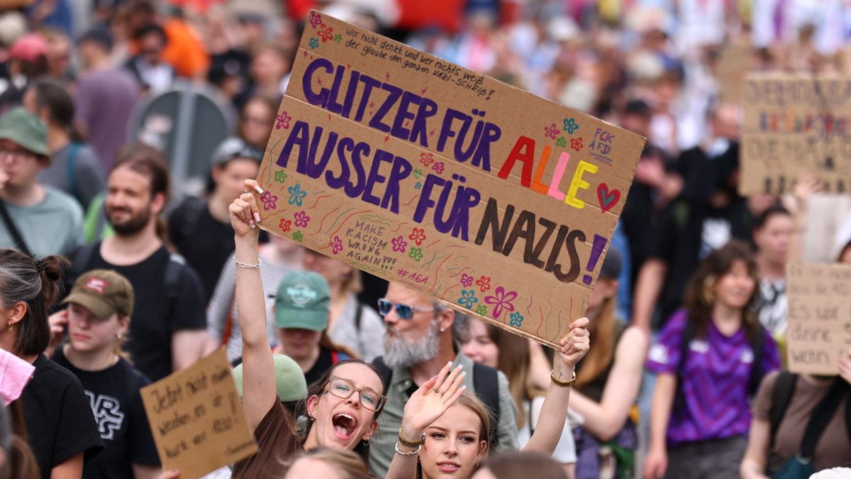 People hold a sign that reads: "Glitter for everyone, except for Nazis" during a protest against a two-day party convention of Germany's far-right Alternative for Germany (AfD) party, Erfurt, Germany, July 4, 2026. (Reuters Photo)