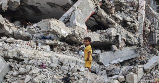 A Palestinian child stands on the rubble of a destroyed building near the al-Shati refugee camp, Gaza City, Palestine, July 1, 2026. (AFP Photo)