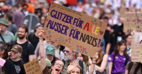 People hold a sign that reads: "Glitter for everyone, except for Nazis" during a protest against a two-day party convention of Germany's far-right Alternative for Germany (AfD) party, Erfurt, Germany, July 4, 2026. (Reuters Photo)
