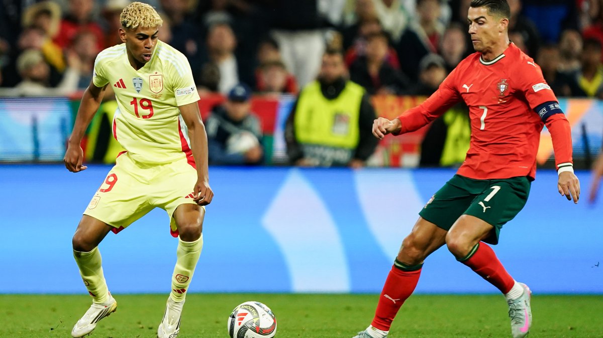 Spain's Lamine Yamal (L) and Portugal's Cristiano Ronaldo go for the ball during the UEFA Nations League 2025 final in Munich, Germany, June 08, 2025. (Getty Images Photo)