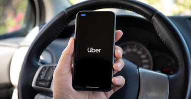 A man holds a mobile phone showing the Uber application on the screen, Antalya, southern Türkiye, Oct. 5, 2020. (Shutterstock Photo)
