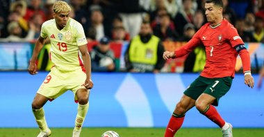 Spain's Lamine Yamal (L) and Portugal's Cristiano Ronaldo go for the ball during the UEFA Nations League 2025 final in Munich, Germany, June 08, 2025. (Getty Images Photo)
