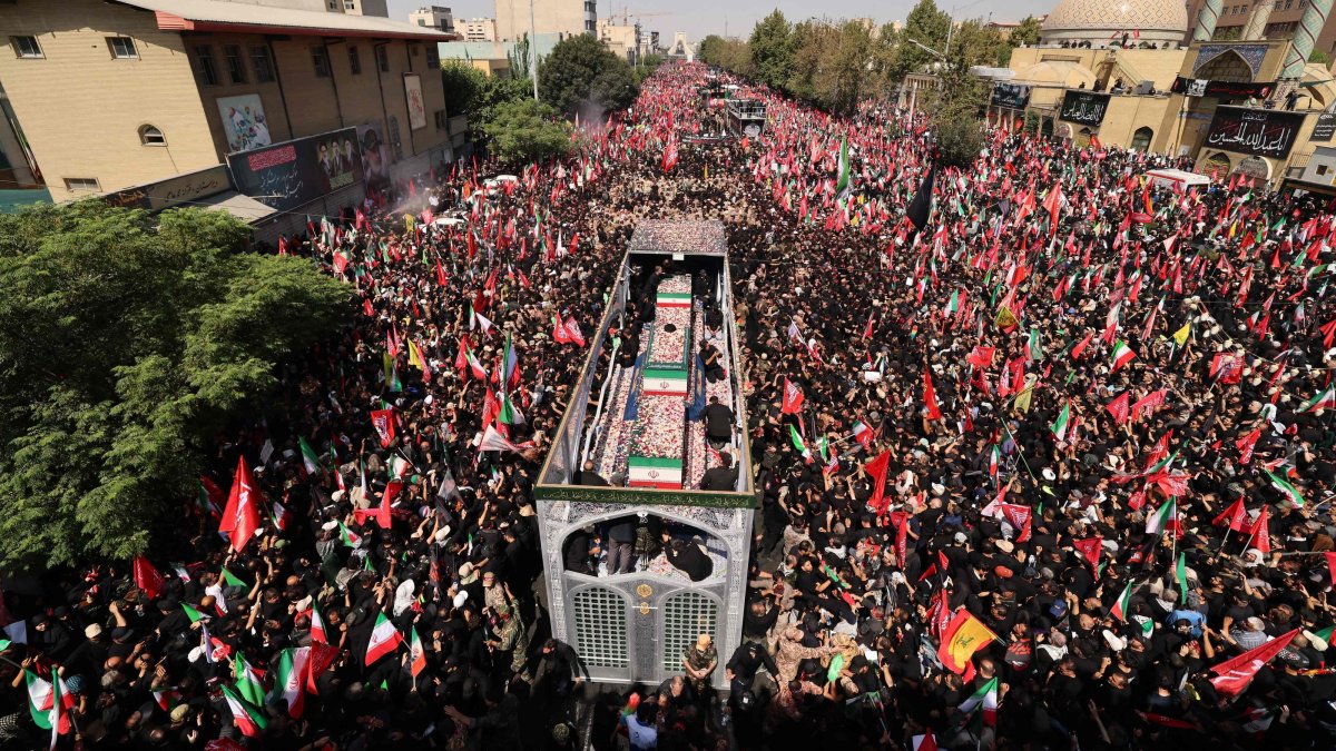 People gather along a street during the funeral procession of Iran's slain Supreme Leader Ali Khamenei and his family members in Tehran, Iran, July 6, 2026. (AFP Photo)