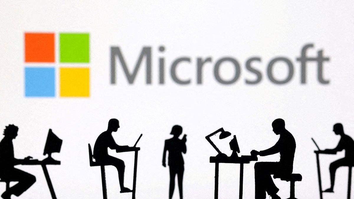 Figurines with computers and smartphones are seen in front of Microsoft Corporation logo in this illustration taken Feb. 19, 2024. (Reuters Photo)