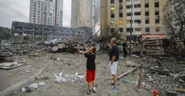 Locals react at the site of a Russian strike on a residential area in Kyiv, Ukraine, July 6, 2026. (EPA Photo)