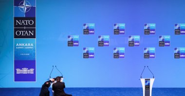 People adjust a lectern in the main press conference room a day before the start of the NATO summit in Ankara, Türkiye, July 6, 2026. (Reuters Photo)