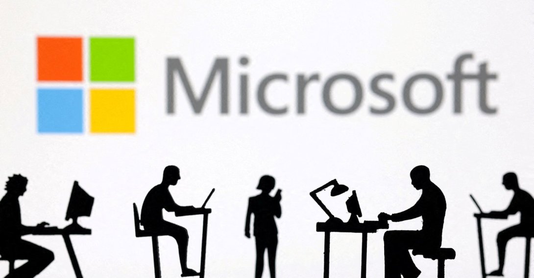Figurines with computers and smartphones are seen in front of Microsoft Corporation logo in this illustration taken Feb. 19, 2024. (Reuters Photo)