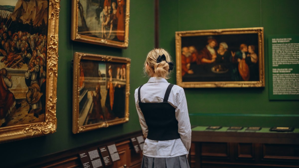 A woman examines the paintings in an art museum, Dresden, Germany, Dec. 25, 2024. (Shutterstock Photo)