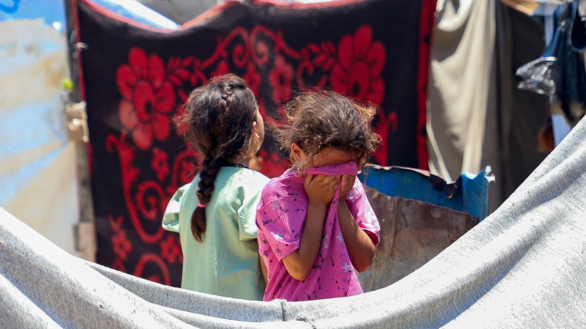 A child reacts as Palestinians inspect the site of an Israeli strike on a tent at a camp sheltering displaced people, in Gaza City, July 7, 2026. REUTERS/Ebrahim Hajjaj